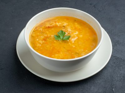 front-view-delicious-soup-inside-white-plate-dark-surface