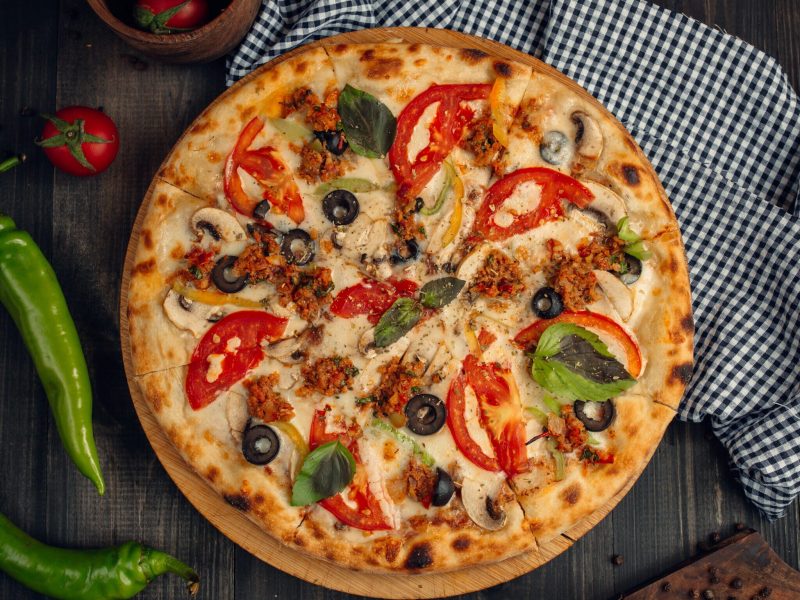 mix pizza with tomato slices, mushroom, olive, basil leaves, and minced meat